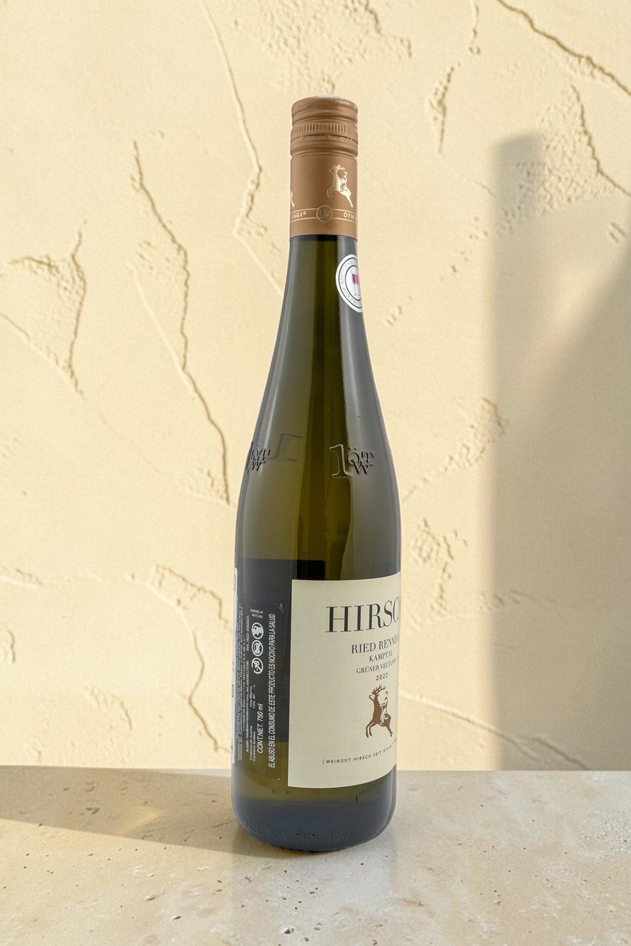 Botella de vino blanco Hirsch VB Ried Renner Gruner Veltliner de Wellnex sobre fondo neutro con iluminación suave