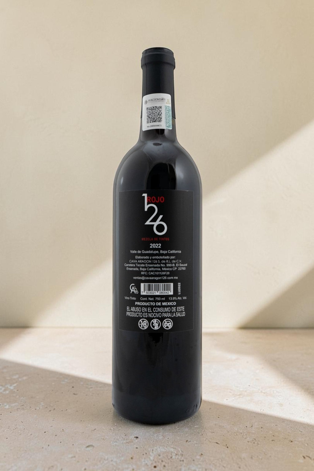 Botella de vino tinto Wellnex Rojo 126 Mezcla de Vinos con etiqueta trasera detallada sobre fondo neutro