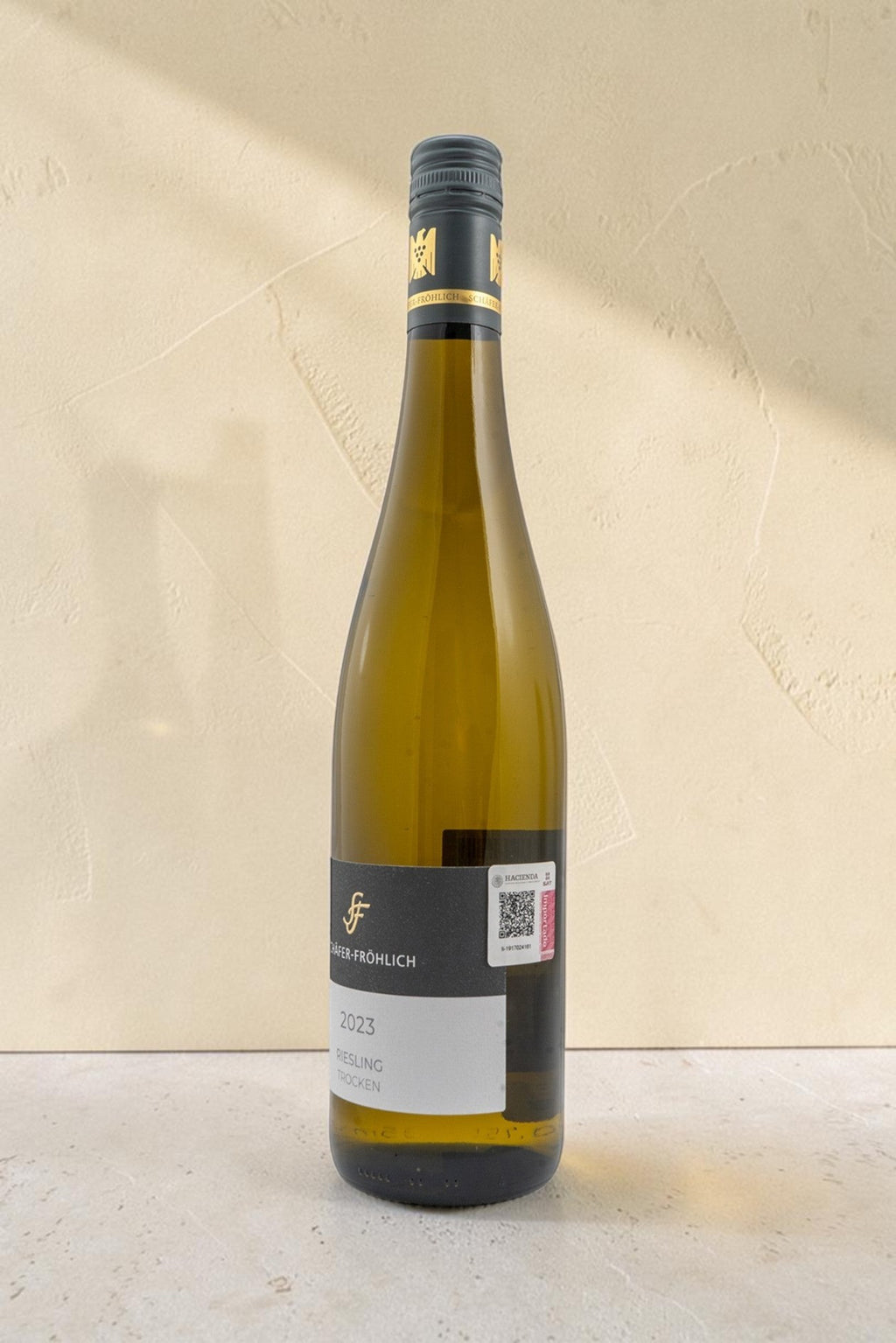 Botella de vino blanco Wellnex Schafer Frohlich Riesling Trocken 2023 con etiqueta elegante sobre fondo neutro
