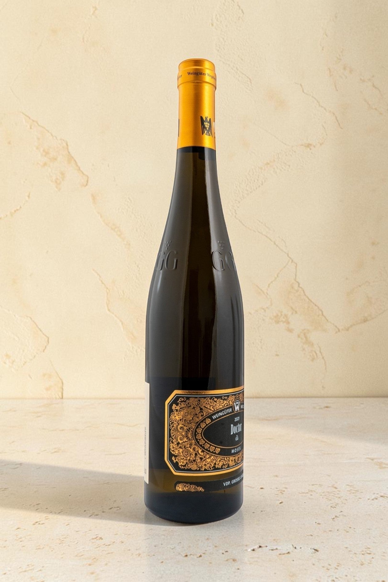 Botella de vino blanco Wellnex Weingut Wegeler Bernkasteler Doctor Riesling GG con etiqueta dorada ornamentada