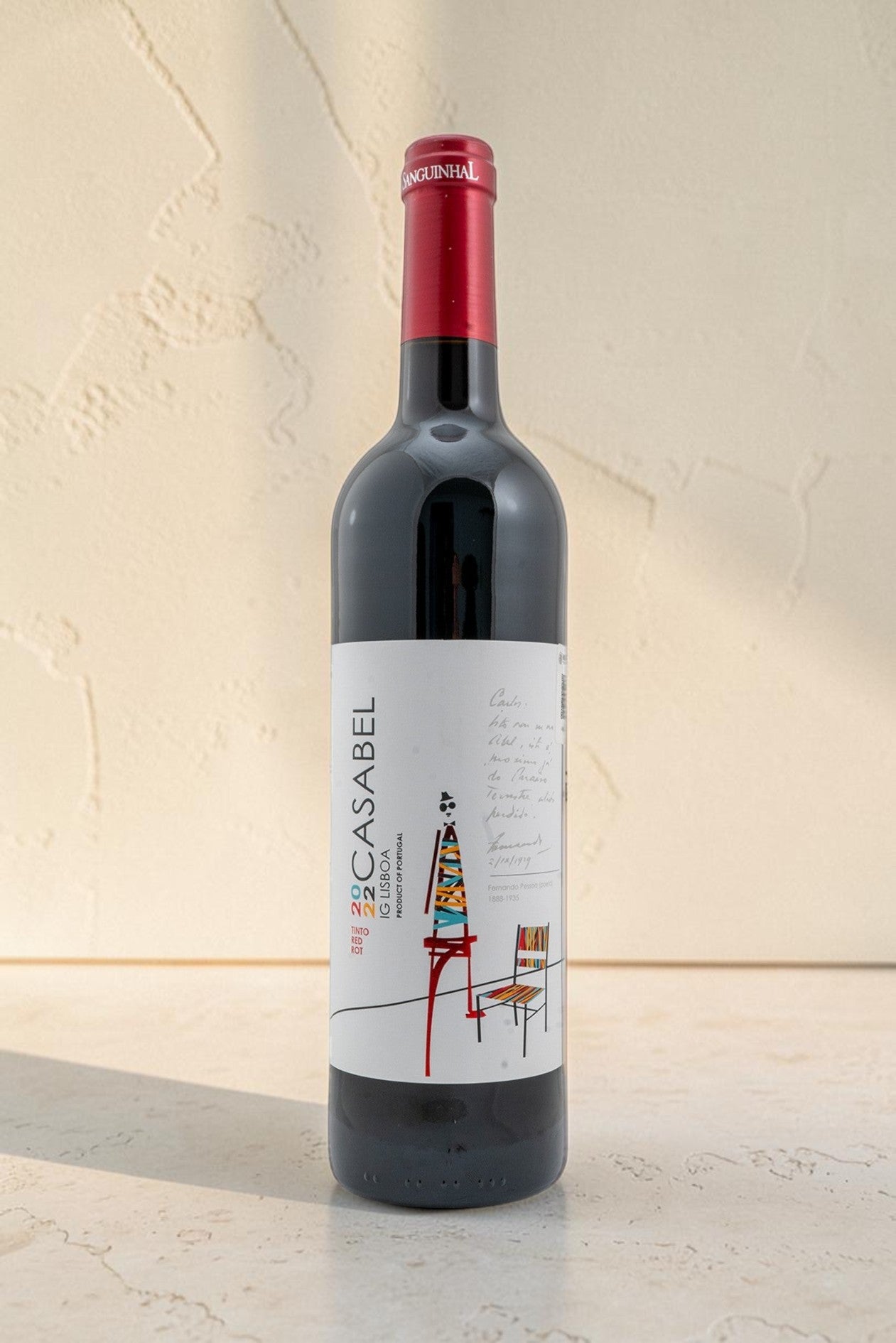 Botella de vino tinto Casabel de Wellnex con etiqueta ilustrada, cápsula roja y diseño elegante sobre fondo neutro.