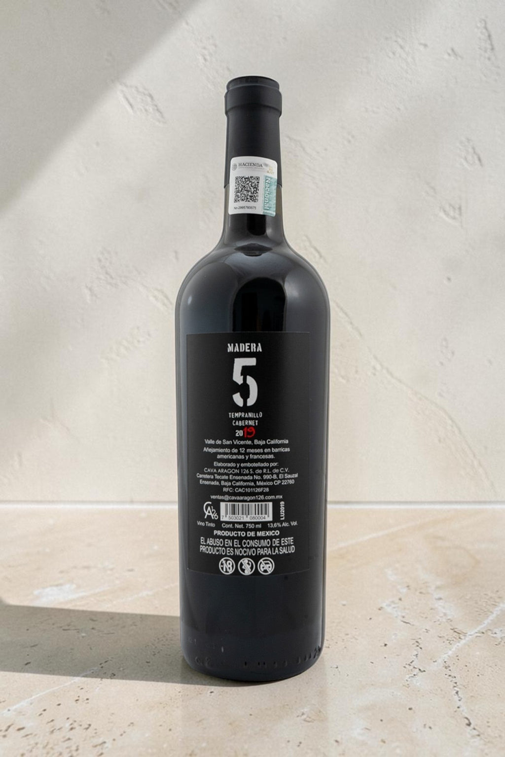 Botella de vino tinto Wellnex Tempranillo Cabernet con etiqueta negra y detalles en blanco sobre fondo neutro.